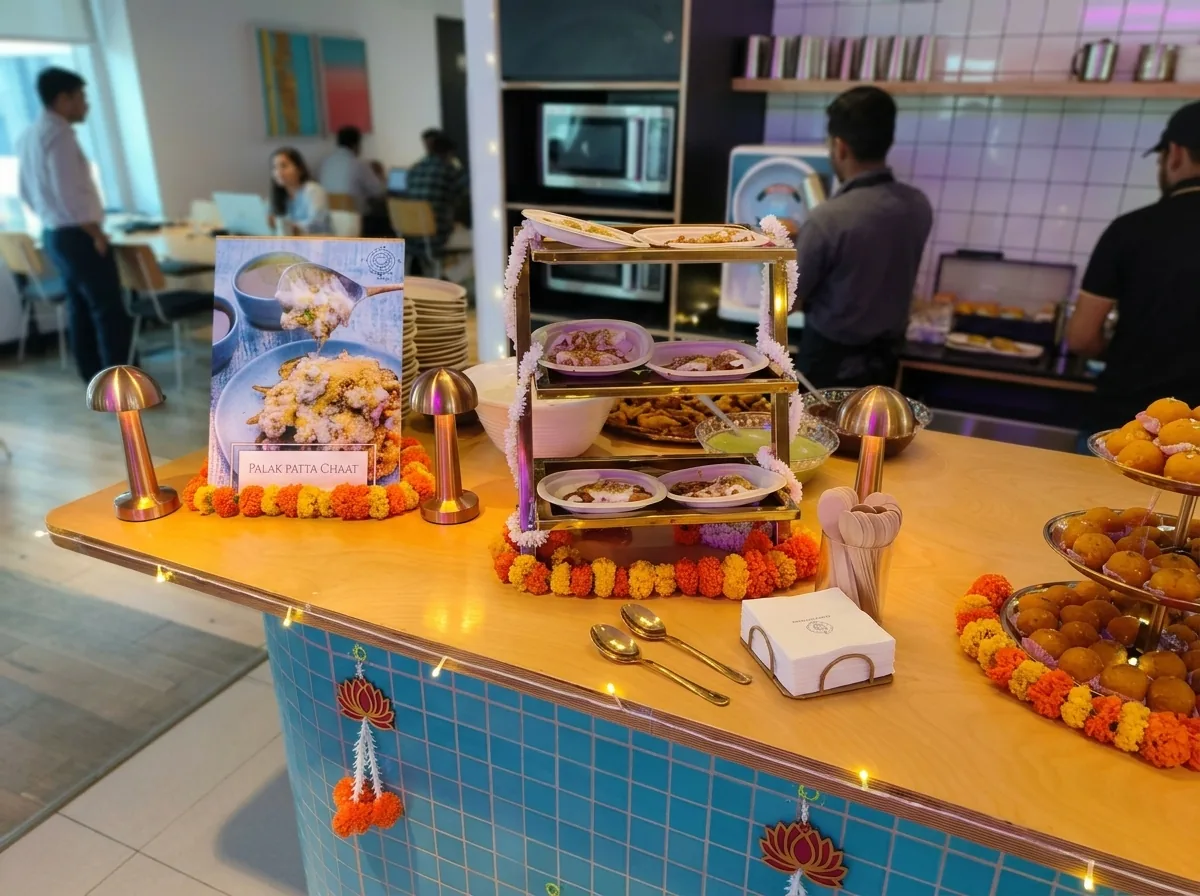 Office pantry counter dressed with marigold garlands and tiered festive snacks