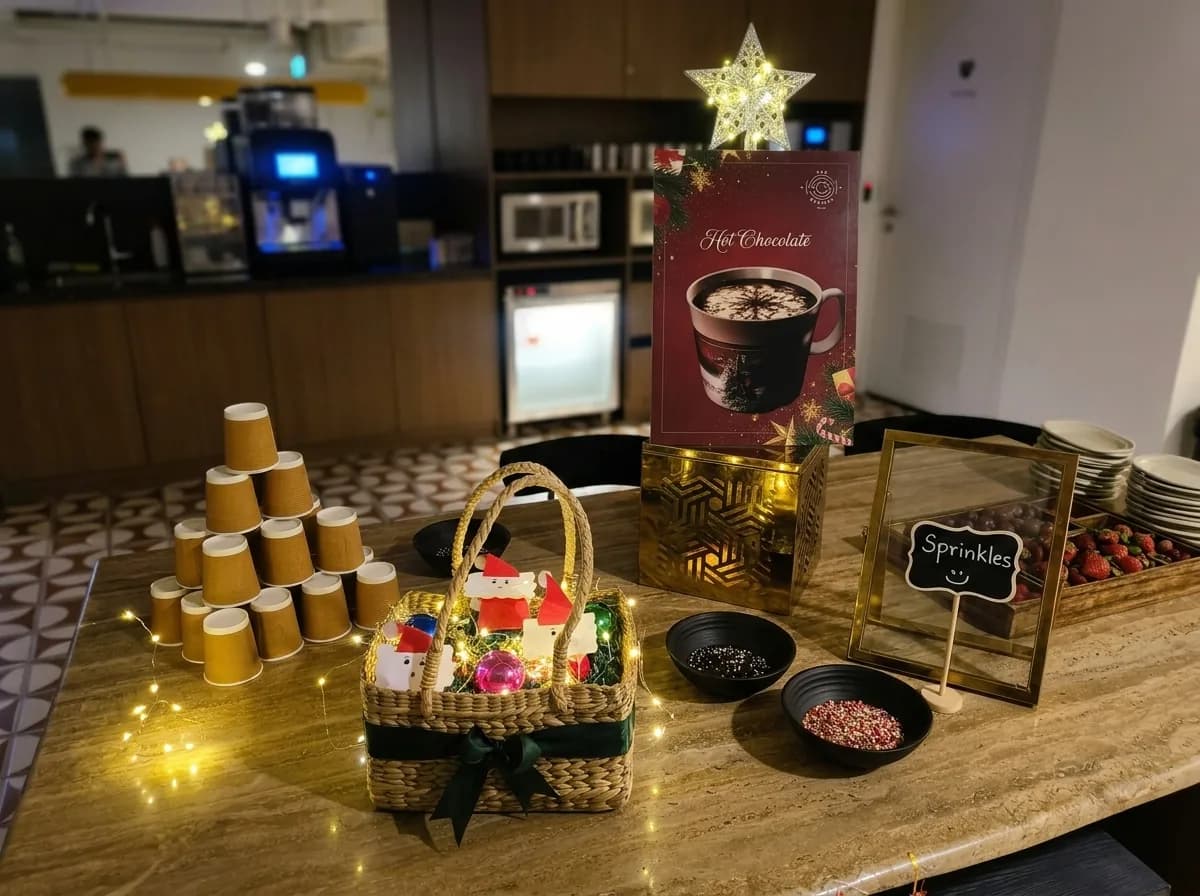 Winter hot chocolate station with stacked cups, fairy lights and a seasonal menu card