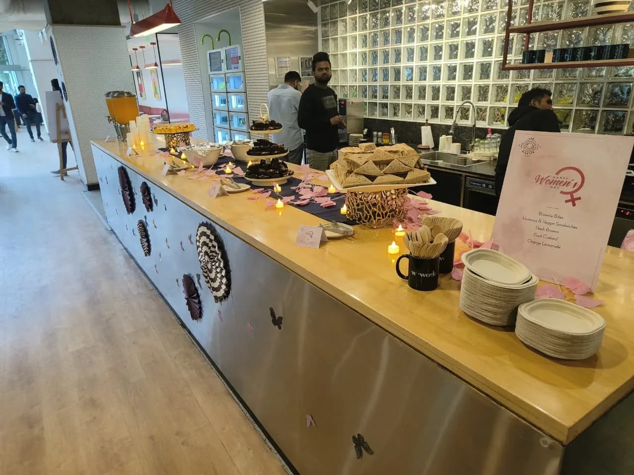 The Dinette kiosk in service, staff behind a long counter set with pastries and signage